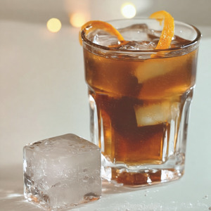 An image of the Four Forte cocktail submitted by Toby that contains Agricole Rhum, Old Monk Rum, Smith & Cross, Goslings Black Seal 151, Angostura Bitters, Orange Bitters, Whiskey Barrel Aged Bitters and Xocolatl Mole Bitters and Demerara SugarOrange