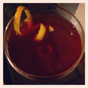 An image of the And To All A Good Night cocktail submitted by n0tquitethere that contains Bourbon, Reposado Tequila, Cherry Brandy, Orange Bitters, Angostura Bitters and Orange