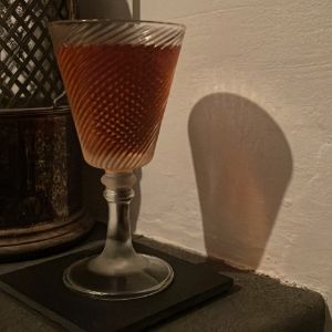 An image of the Fall Back cocktail submitted by Toby that contains Rye Whiskey, Apple Brandy, Amaro Nonino, Sweet Vermouth, Peychauds Bitters and Orange