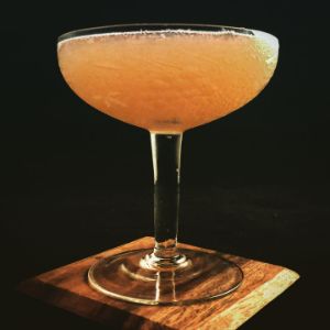 An image of the Heirloom cocktail submitted by n0tquitethere that contains Old Tom Gin, Cynar, Lime, Strega, White Grapes and Absinthe