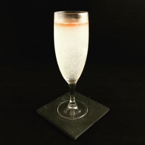 An image of the Juan's Flying Burrito cocktail submitted by n0tquitethere that contains Mezcal, Lime, Curaçao Triple Sec, Sparkling Wine and Peychauds Bitters